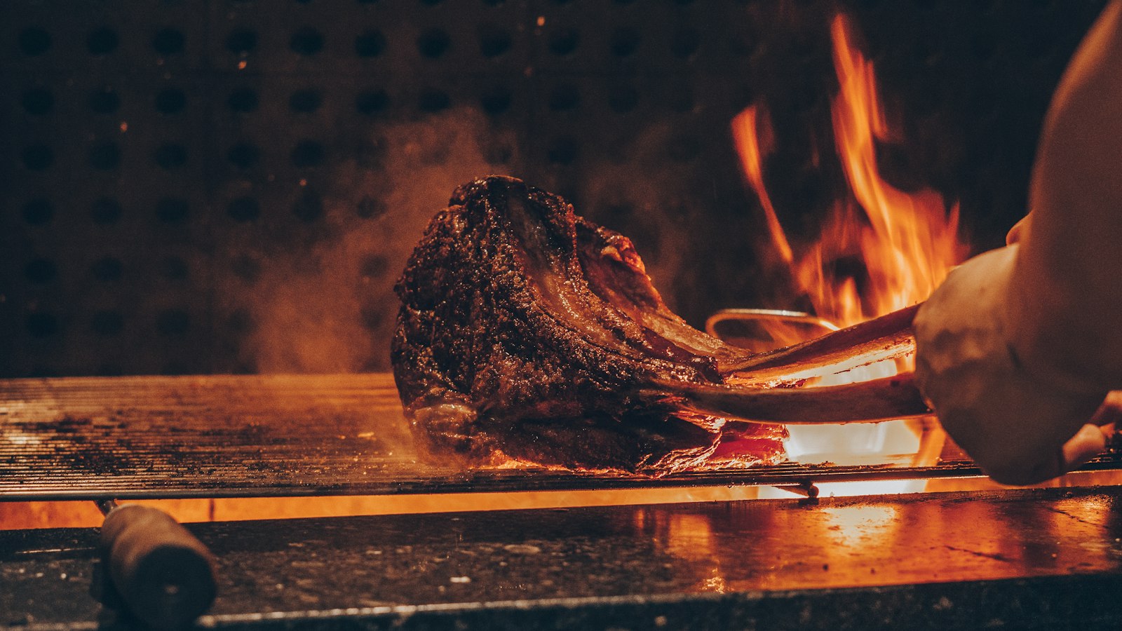 Farm meat grilling over coals on a braai at Zania Farm